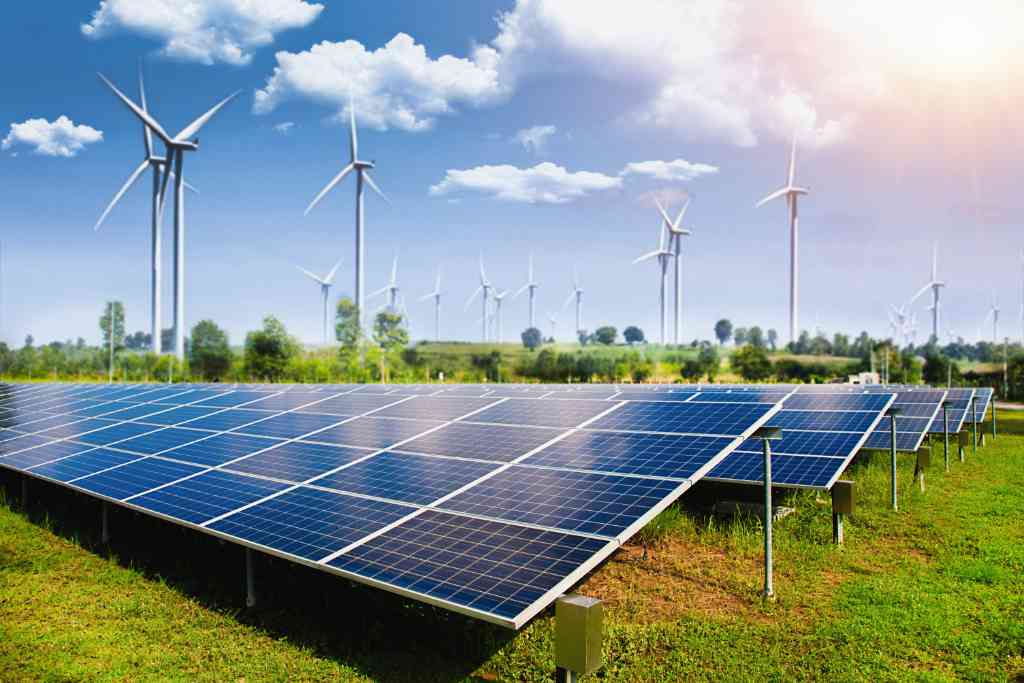 solar-panel-with-wind-turbines-against-mountains-sky